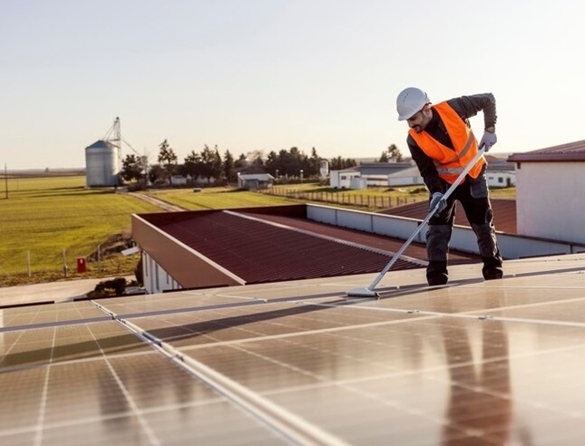 Tidy worker is cleaning Solar Panels